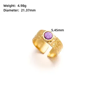 Gold-plated open ring with a 5.45mm purple stone and hammered texture details