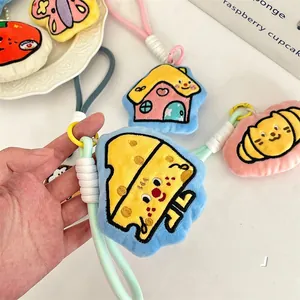 Detail of colorful plush cartoon pendants with embroidery and thick braided ropes