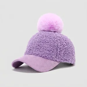 Detail of purple sherpa baseball cap for kids with large fluffy pompom on top