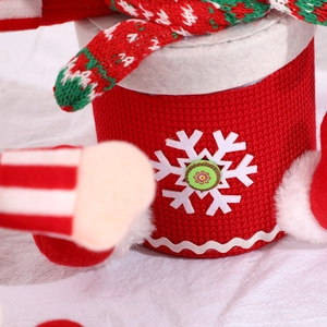 Christmas themed red knitted candy jar with white snowflake patterns and plush toy details