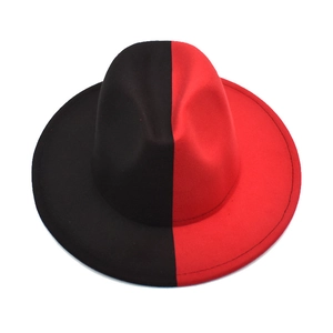 Detailed top view of a two-tone red and black fedora hat with a wide brim on white background