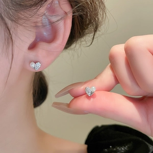 Elegant heart-shaped stud earrings with zircons and pearls on silver-tone metal