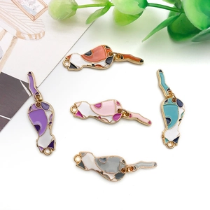 Detailed flat lay of colorful enamel cat charms for DIY jewelry making and crafts