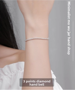 Detailed close-up of S925 silver 2mm moissanite bracelet on a female wrist