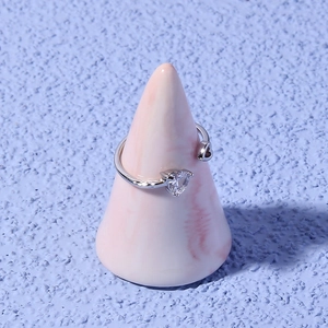 Detail view of silver heart-shaped adjustable ring featuring a sparkling zircon stone