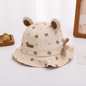 Close-up of beige corduroy baby bucket hat featuring 3D bear ears and cute prints