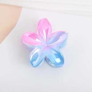 Detail of pink and blue gradient marble hair claw clip with a glossy floral finish