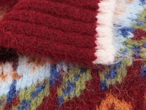 Close-up of multicolored jacquard knit cardigan with soft long-haired mohair texture