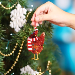 Chicken Christmas ornament with scarf and LED lights hanging on a festive Xmas tree