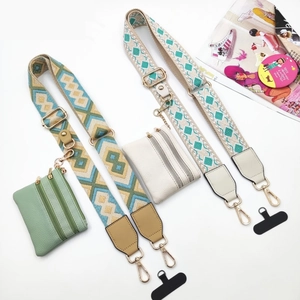 Detail of woven crossbody phone straps with matching leather coin purses and metal clasps