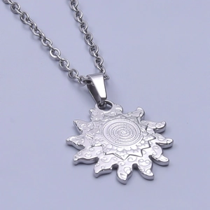 Macro view of silver sun pendant featuring spiral center and sunburst pattern on O-chain
