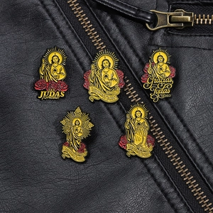 Macro detail of religious Saint Jude enamel pins with rose accents on black leather
