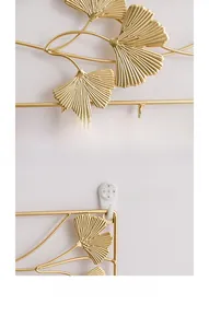 Detailed view of golden ginkgo leaf wall decor with clear metal texture and seamless nail
