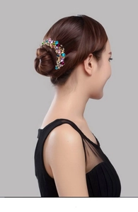 Detailed side view of a vintage alloy hair comb with colorful rhinestones on a hair bun