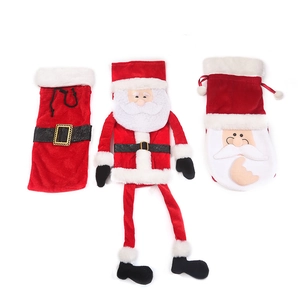 Three assorted Christmas Santa velvet wine bottle covers with white faux fur trim and belts