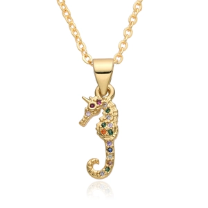 Macro detail of a gold seahorse pendant with colorful zircon stones on a white background