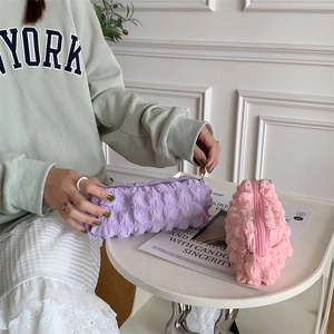 Detail of soft bubble texture on purple and pink fabric stationery storage bags