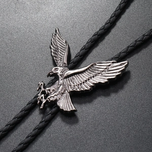 Detailed view of silver-tone eagle bolo tie pendant with black braided leather cord