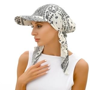 Detail of white paisley bandana hat with black floral pattern and side tie design