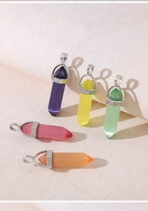Detailed view of five hexagonal crystal pendants in purple, pink, and green with silver clasps