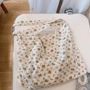 Detail view of cotton tote bag with delicate blue and orange floral pattern