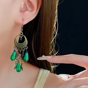 Bohemian retro gold crescent earrings with emerald green teardrop beads and leaf charms