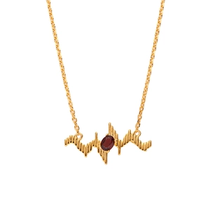 Elegant gold S925 silver necklace featuring a red topaz stone in a heartbeat pendant design