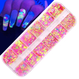 Detailed macro view showing 12-grid fluorescent nail art sequins in various shapes