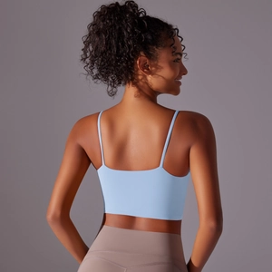 Detail of light blue high-stretch sports bra with thin straps and seamless back design