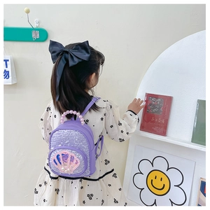 Detail of purple sequin toddler backpack with shell pattern and pearl bead handle