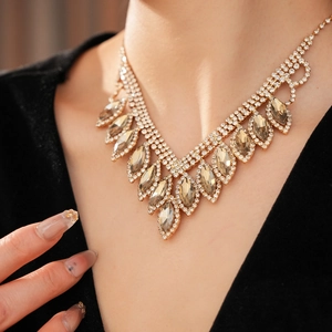 Close-up of luxury gold necklace with champagne teardrop crystals on a model's neck