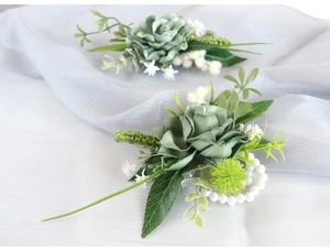 Detail of sage green artificial rose corsage and wrist flower with pearls for weddings