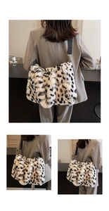 Detail showing the fluffy leopard print plush fabric and black strap of the tote bag