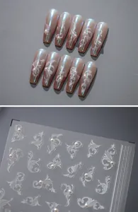 Close-up of 5D floral lace nail stickers with 3D pearls on pearlescent base nails