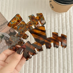 French tortoise shell hair claw clips set on minimalist aesthetic lifestyle background