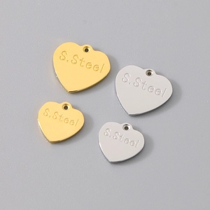 Macro view of heart-shaped stainless steel charms in gold and silver finish