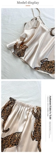 Detail of leopard print satin sleepwear set showing V-neck camisole and silk luster fabric