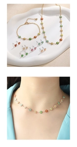 Detailed set of colorful enamel daisy necklace, bracelet, and multi-colored stud earrings