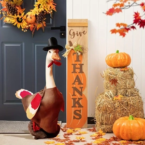 Detail of pilgrim outfit for garden goose statue with Give Thanks wooden sign for porch decor
