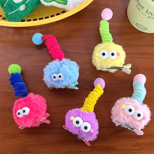 Detailed set of five colorful plush monster hair clips with googly eyes and spiral antennae