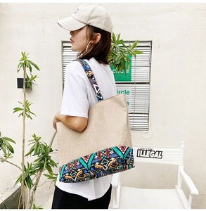 Detail view of large ethnic patchwork canvas tote bag with colorful tribal straps