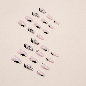 Almond fake nails with black leaf designs and silver glitter on pink base