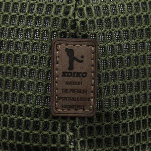Macro shot of breathable dark green mesh fabric with a stitched brown leather EDIKO label