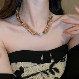 Detail of multilayer crystal beaded necklace with golden tones and a magnetic clasp
