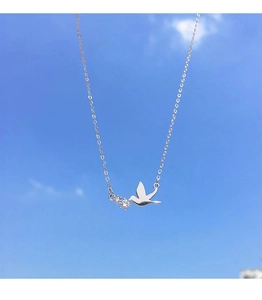 Detailed view of S925 sterling silver flying bird pendant necklace with sparkling stones