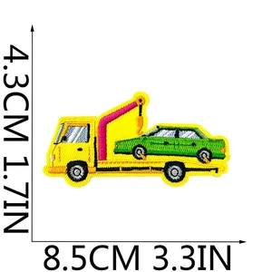 Detailed view of yellow tow truck embroidery patch with 8.5cm by 4.3cm dimensions