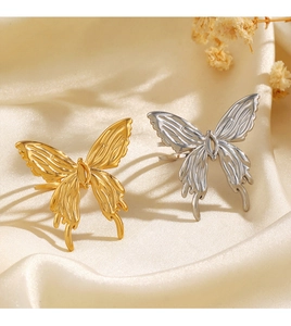 Detailed view of gold and silver butterfly rings with intricate hollow wing textures