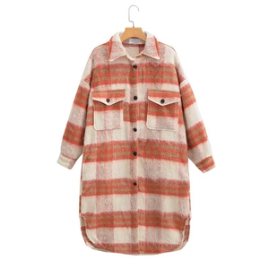 Close-up of oversized plaid shacket texture with orange, beige and brown checkered wool fabric