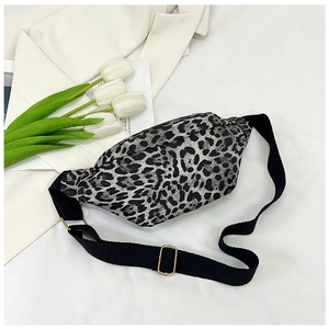 Detail of leopard print crossbody bag with black adjustable strap and metal buckle