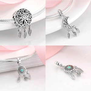 Macro details of S925 sterling silver dreamcatcher charms with turquoise and feathers